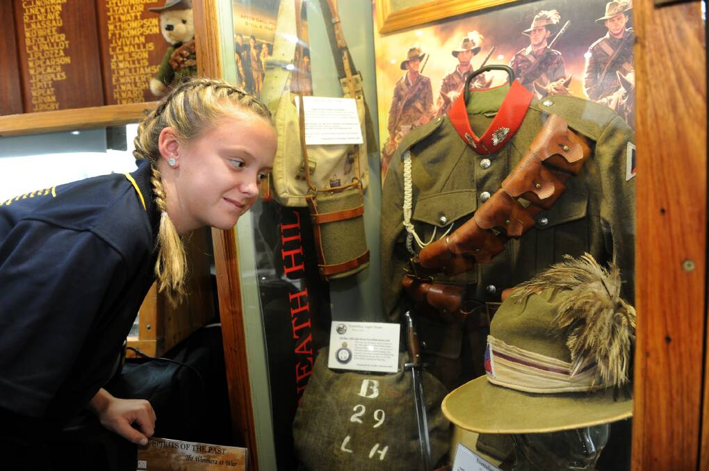 Horsham West Primary School student Ruby Hill examines artefacts at the Horsham RSL's Spirits of the Past, The Wimmera at War exhibition. Picture: PAUL CARRACHER