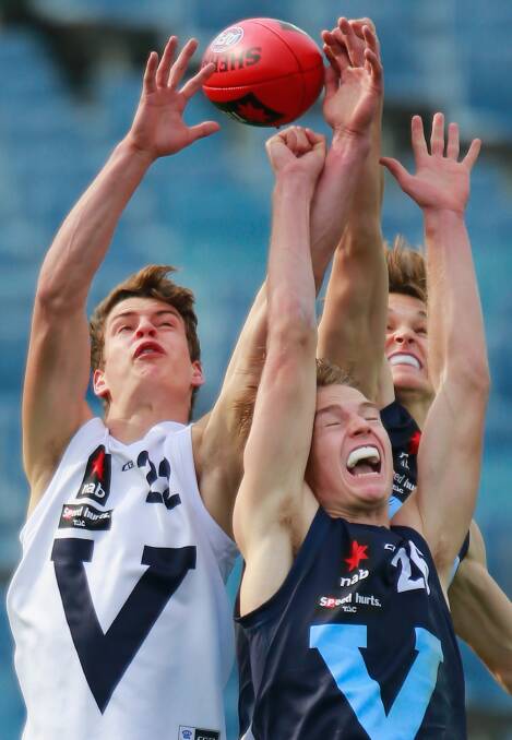 STRENGTH: Vic Country's Jarrod Berry reaches for a mark against Vic Metro's Daniel Beddison during an Under 18 Championship match at Geelong's Simonds Stadium at the weekend. Picture: GETTY IMAGES