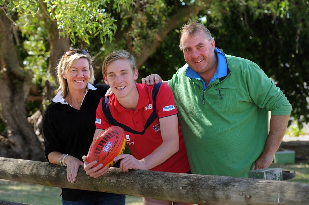 GOOD GENES: Oscar McDonald with parents Cath and Paul after being drafted by the Melbourne Demons last month. It was a big year for the McDonald family, with Oscar's brother Tom succeeding at AFL level and sister Sacha making an impact in several sports including netball, basketball and tennis. Picture: PAUL CARRACHER