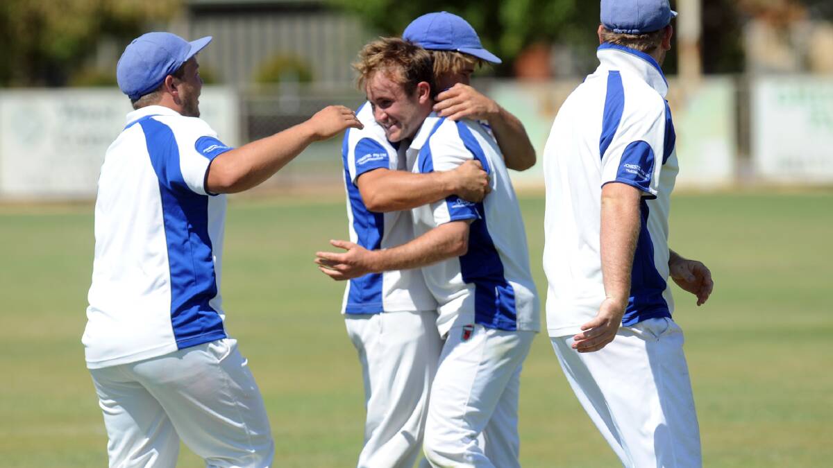 TRIUMPH: Winiam players embrace Adam Bound after a wicket. Picture: PAUL CARRACHER