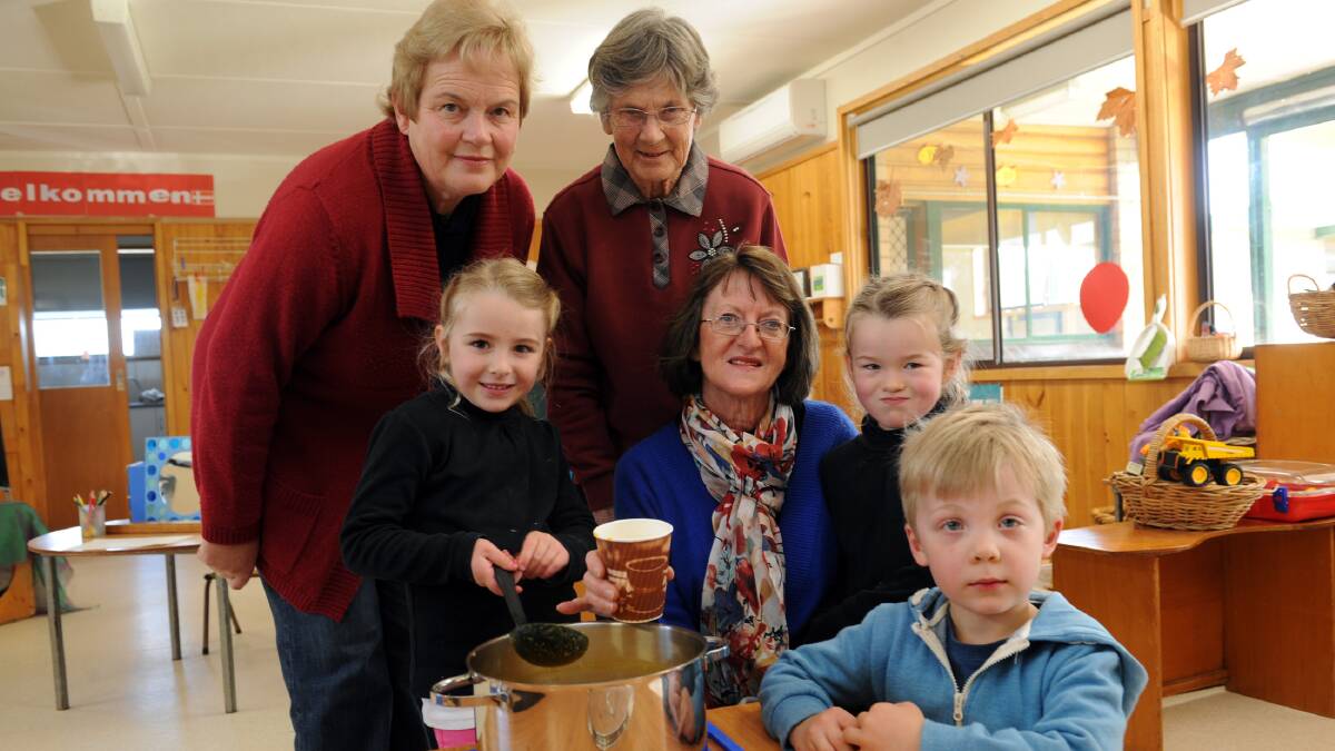 OLD AND NEW: Emma Uebergang, front left, serves soup to her grandmother Elaine Uebergang, sitting, as Hayley Uebergang and Toby Uebergang supervise. Natimuk CWA members Janette Sudholz and Judy Mann also wait for a cup at Natimuk Preschool. Picture: PAUL CARRACHER