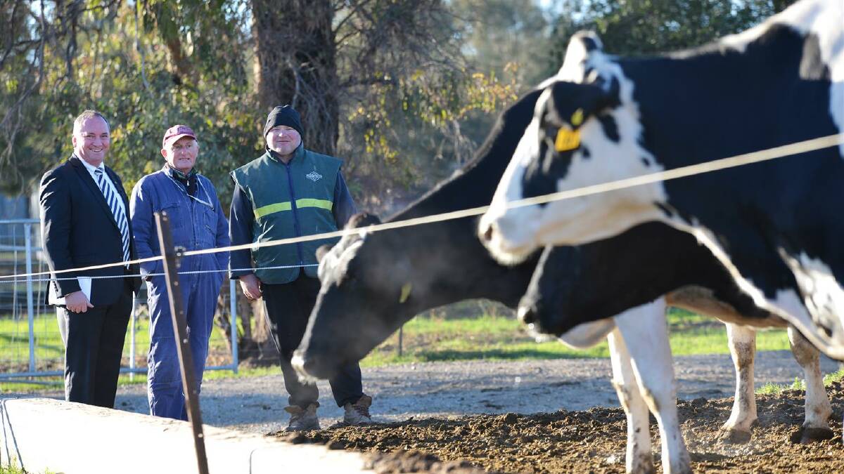 Agriculture Minister Barnaby Joyce with Tamworth dairy farmers Terry and Scott Tout. Pic: Barry Smith
