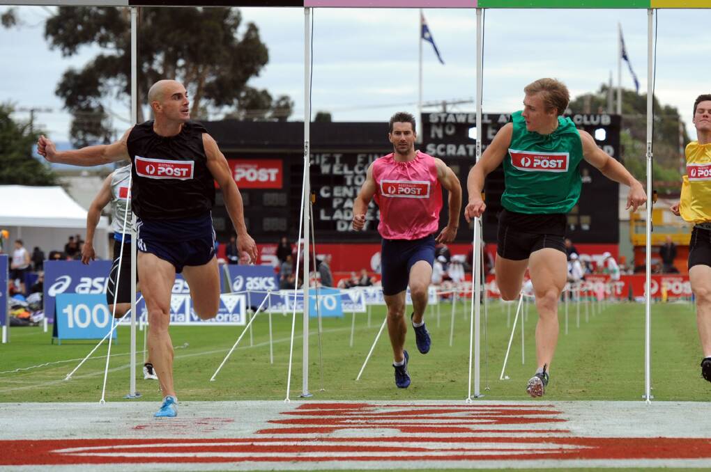 TIGHT FINISH: Luke Versace, black, and Isaac Dunmall, green, didn't give an each in their Stawell Gift heat. Both qualified for the semi-finals on Monday. Picture: PAUL CARRACHER