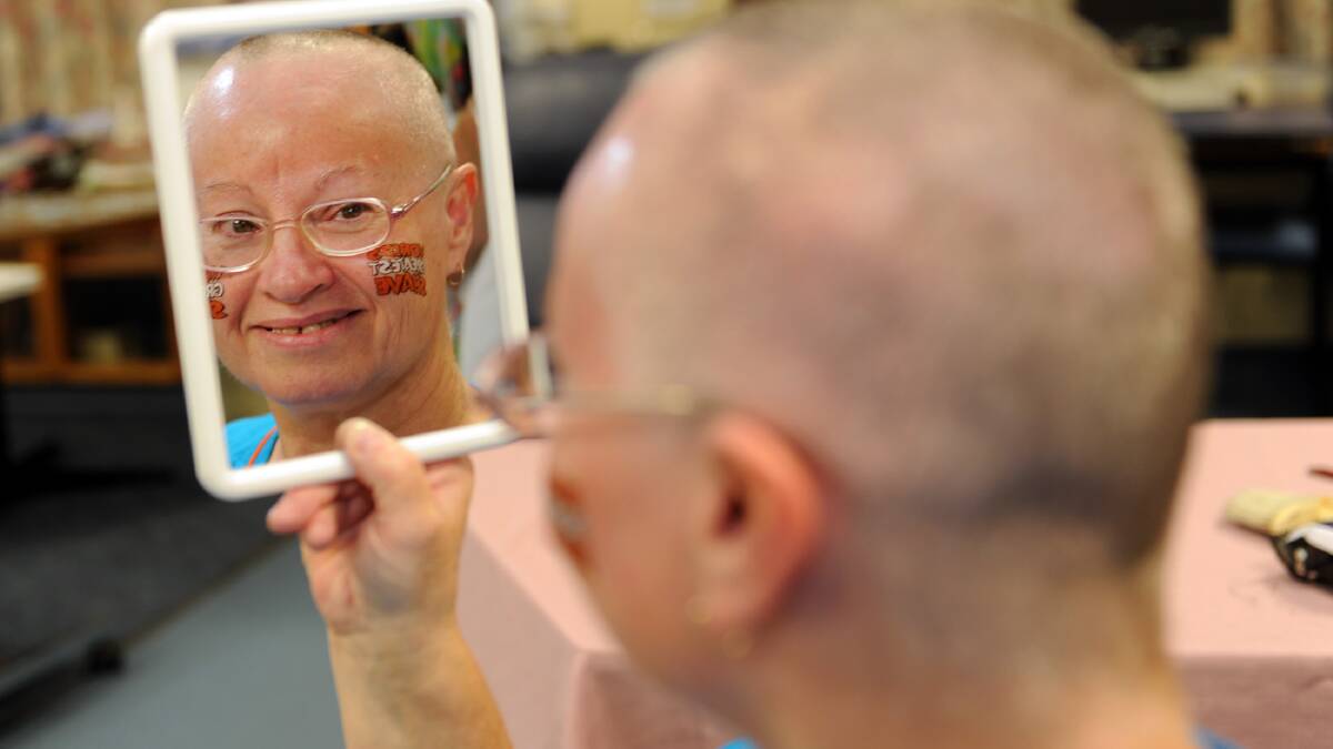 A CLOSE SHAVE: Kerri Francisco of Horsham takes a look at her new hairstyle after shaving her head yesterday to raise money for cancer research. For more, see page 3. Picture: PAUL CARRACHER