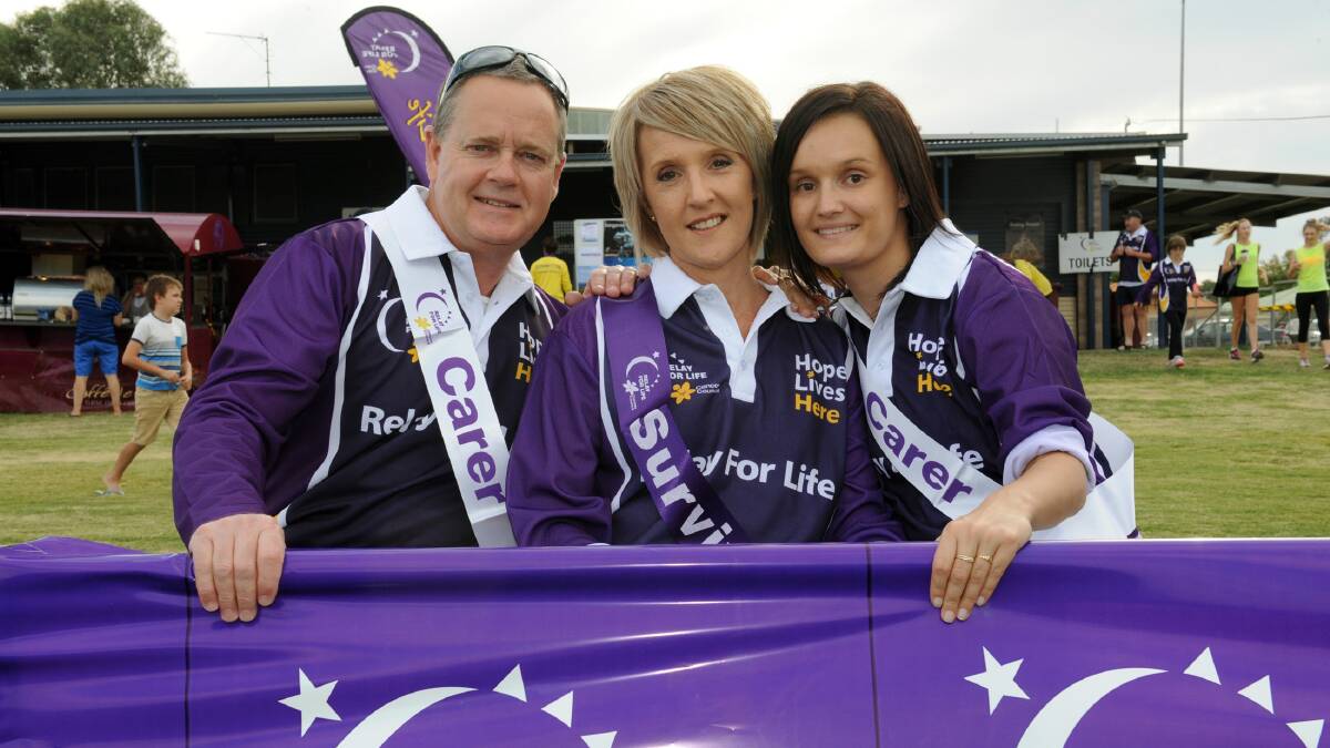 SUPPORT: Horsham’s Jenny Clayton, centre, with husband Don Clayton and daughter Ebony Clayton. Mrs Clayton cut the ribbon to mark the start of the Horsham and District Relay for Life on Friday. Picture: PAUL CARRACHER