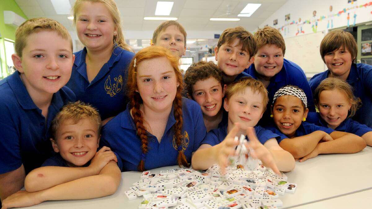 Halls Gap Primary School grades 4 to 6 students show off dominoes they will use to create a massive domino chain for a Woolworths competition. Picture: SAMANTHA CAMARRI
