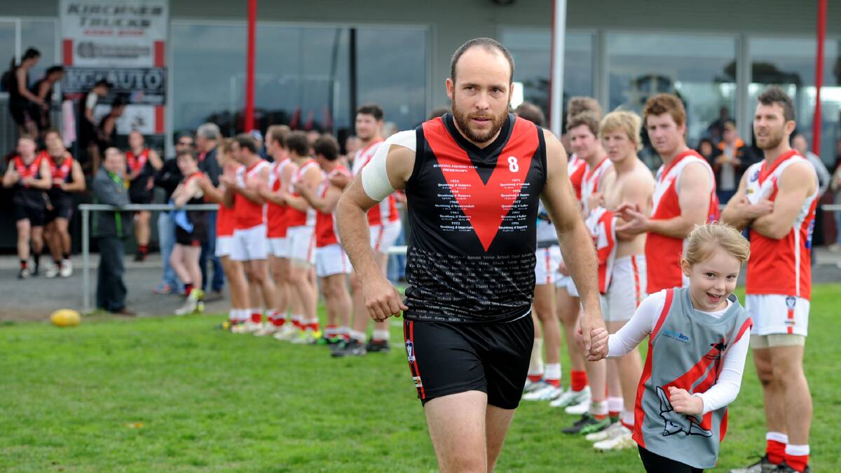SPECIAL MOMENT: Noradjuha-Quantong’s Brent McIntyre runs out for his 300th club game with daughter Izabella on Saturday, as Taylors Lake players form a guard of honour. For more on McIntyre’s 300th game, see page 30. Picture: SAMANTHA CAMARRI