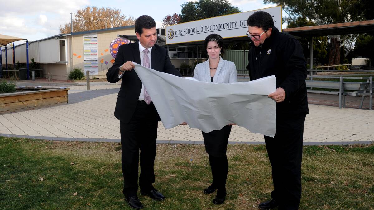 Opposition education spokesman Nick Wakeling, Member for Lowan Emma Kealy and Horsham College principal Rob Pyers look at the plans for the school’s redevelopment. Picture: SAMANTHA CAMARRI