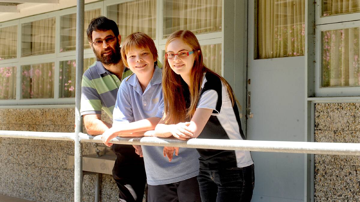 PLEASE REBUILD: Horsham dentist Dr Bret Sonnberger and his children Nathan, 12, and Laura, 17 - pictured in February 2012 - would like to see Horsham College rebuilt. Laura completed year 12 at the school in 2011 and Nathan started year seven in 2012. Picture: SAMANTHA CAMARRI