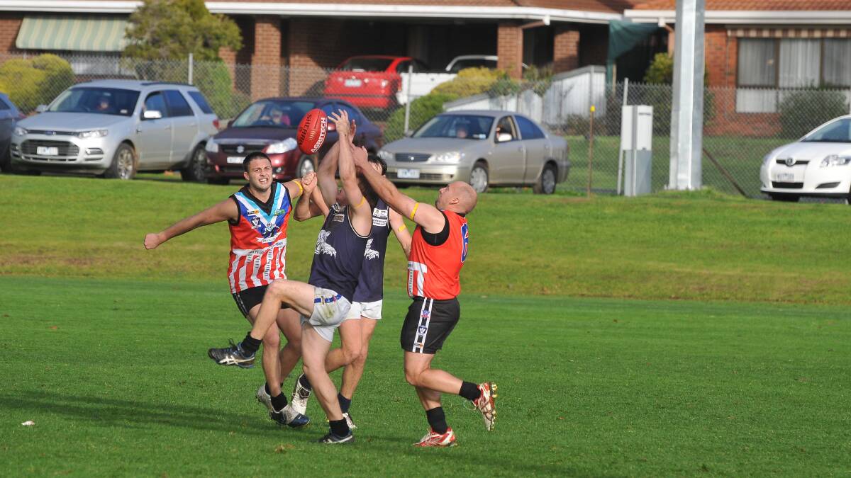STILL AT IT: Swifts’ Jamie Britten, right, crashes a pack against Rupanyup in his 400th district league game at the weekend. Picture: STAWELL TIMES-NEWS