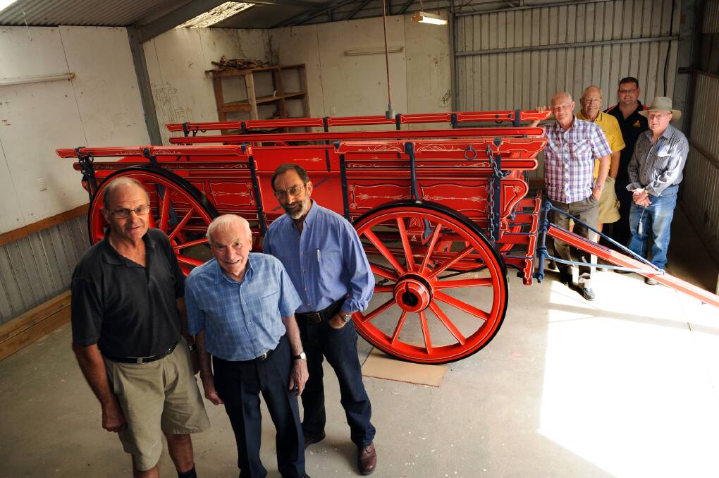 WHEELS OF HISTORY: Chas McDonald, Cyril Carracher and Don Mitchell, front, rebuilt an old May and Millar wagon. Don Johns, Barry Bell, Tim Batchelor and Jim Heard, back, admire their work. Picture: PAUL CARRACHER