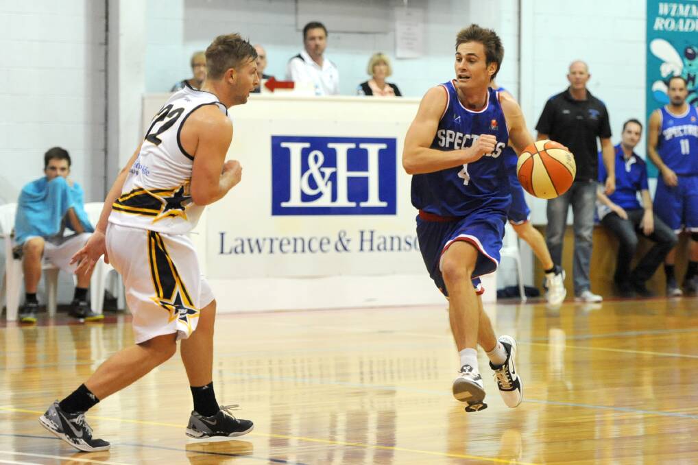 HOMETOWN CROWD: Former Horsham man, Nunawading's Shane McDonald, keeps his cool with the ball as Ballarat's Ash Constable approaches.