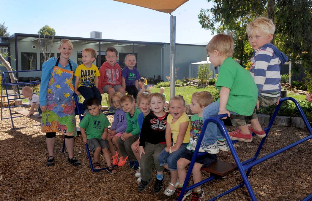 Teacher Katie Waterfield and her 3-year-old Platypus group at Casuarina Kindergarten enjoyed the return to kindergarten this year. Here, they celebrate a new playground provided by Horsham Sports and Community Club. Picture: SAMANTHA CAMARRI
