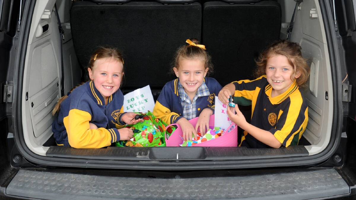 GOODIES GALORE: Tiani Grosser, Madison Scott and Sophie Quick get ready for the Horsham West Primary School parents club’s car boot sale fundraiser. Picture: SAMANTHA CAMARRI
