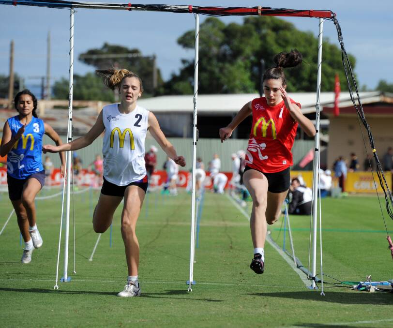 Remi Kuhne, Dimboola, edges out Anna Bush, Horsham, in the Little Athletics 100m handicap heat at Sunday's Stawell Gift family day.
