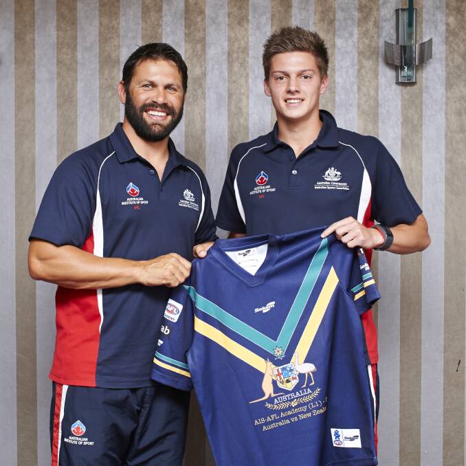 NATIONAL HONOURS: Horsham footballer Darcy Tucker, right, receives his Australian under-17 guernsey from coach and Brisbane Lions great Chris Johnson. Picture: AFL MEDIA