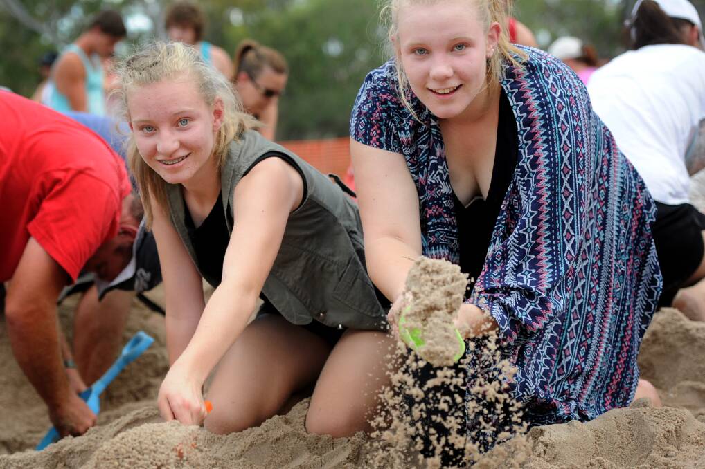 EFFORT: Sisters Taylor and Georgia Hall dig for treasures at the Wimmera River.
