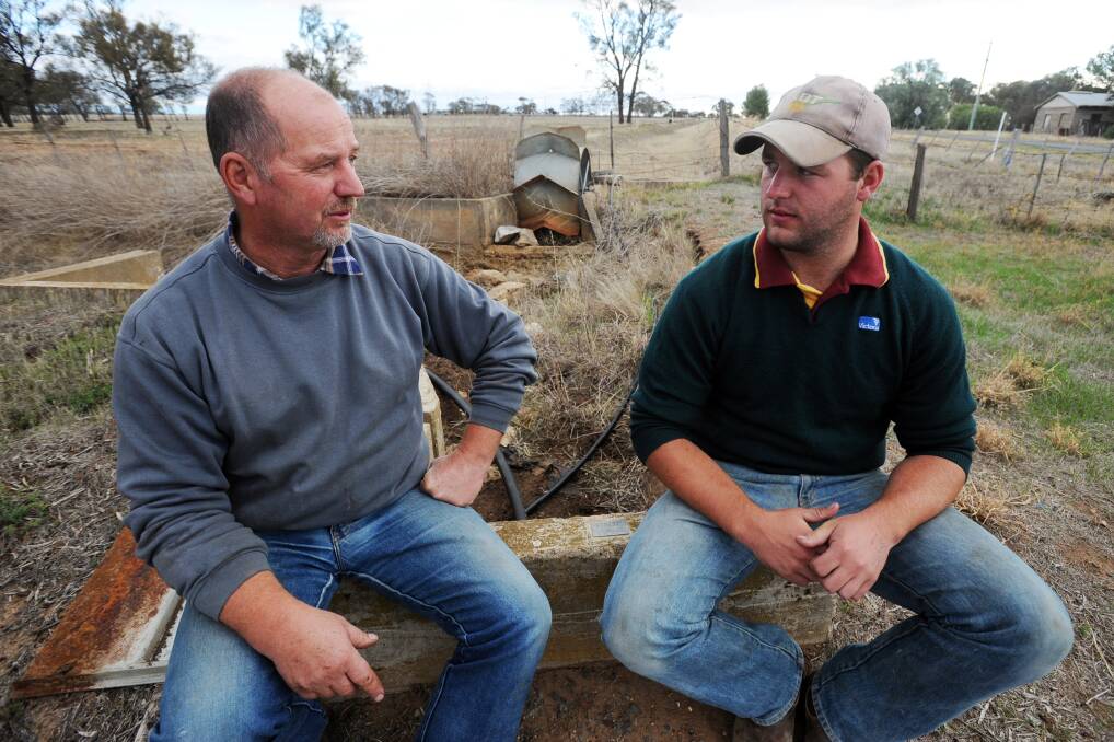 GOOD TIMES: Dale Frankel and his son Warrik Frankel with old irrigation infrastructure. Picture: KATE HEALY