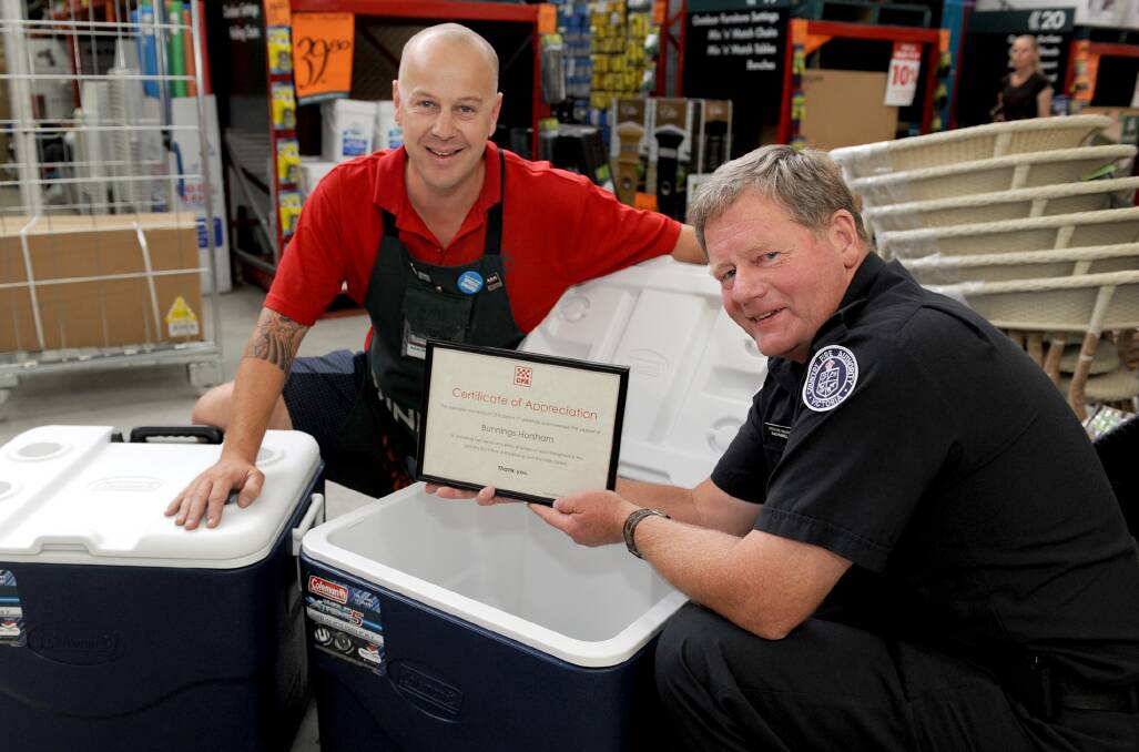 THANKS: Country Fire Authority District 17 operations manager Dale Russell  hands over a certificate of appreciation to Bunnings Horsham assistant store manager Aaron Janetzki for donating eskies and water during the Rocklands and Little Desert fires. Picture: SAMANTHA CAMARRI