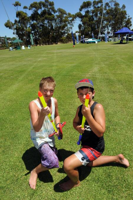 Kaniva Scouts Ben Witmitz and Jeremy Pearson sell water pistols at Kaniva Car and Bike Show.