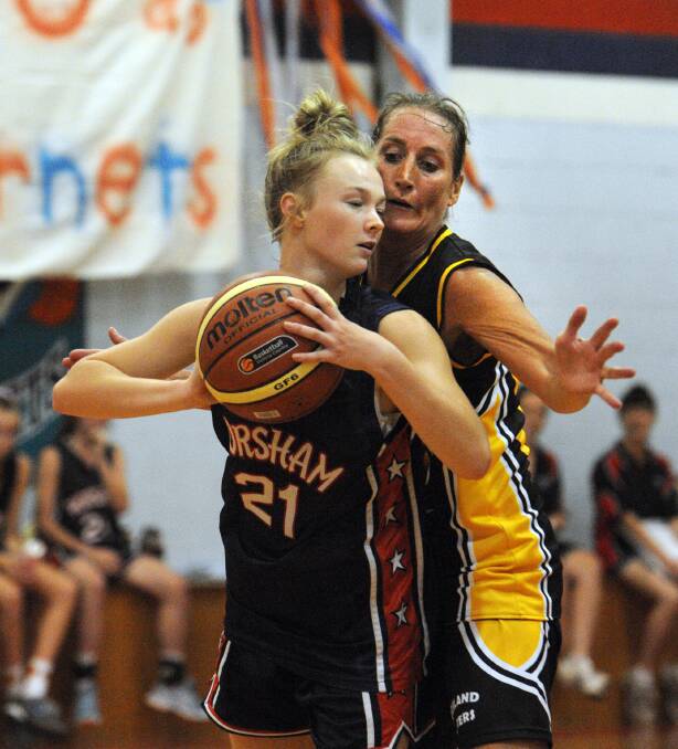 COMPETITION: Horsham Hornet Aily McAuliffe and Portland's Ellen Zeunert put their all in for the grand final on Saturday.