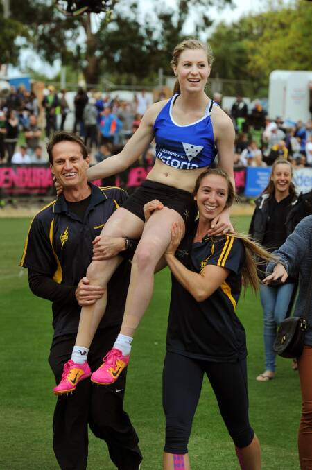 GIFT TRIUMPH: Ballarat’s Holly Dobbyn celebrates her victory on the shoulders of on the shoulders of Peter O'Dwyer and Tara Domaschenz at Central Park on Monday. Pictures: PAUL CARRACHER