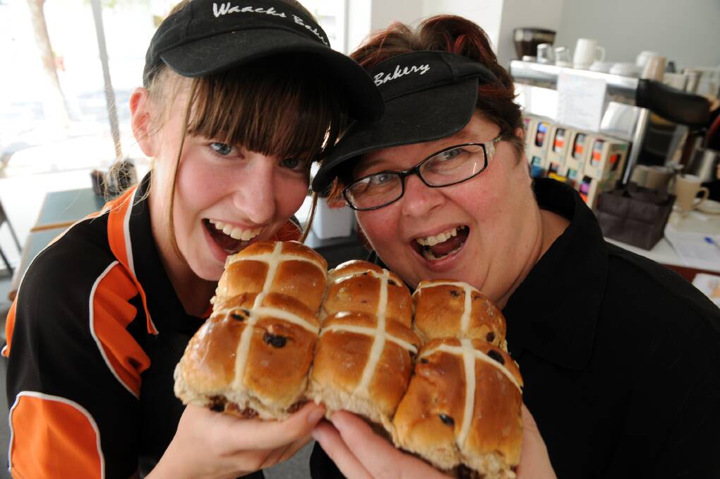 TOP TASTE: Rachel Hateley and Michelle Benson tuck into Waack’s Bakery’s award-winning hot cross buns at the franchise’s Horsham store. Picture: PAUL CARRACHER