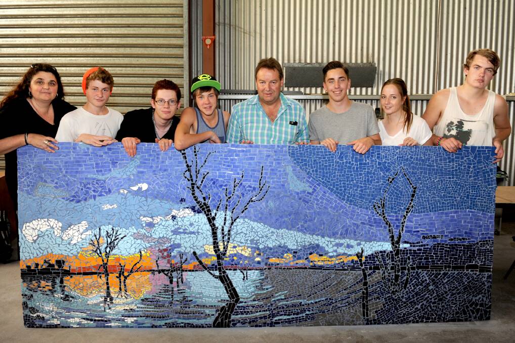 WORK OF ART: Vocational Education Training in Schools tutor Jodie Mathews, photographer Lynton Brown, centre in blue, and students Tyler Ashman-Reed, Jake Finlay, Michael Duffin-Wilde, Tremayne Taylor, Rebecca Roy and Zach Featherstone stand behind their mosaic mural based on a photograph by Mr Brown. Picture: SAMANTHA CAMARRI