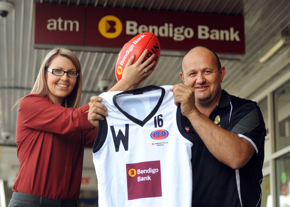 KICKING GOALS: Jenna Wills, representing Wimmera Football League sponsor Bendigo Bank, and Wimmera Football League coach Louie Dalziel show off an interleague jumper. Dalziel’s squad will take on North Central Football League at St Arnaud on May 24. Picture: PAUL CARRACHER