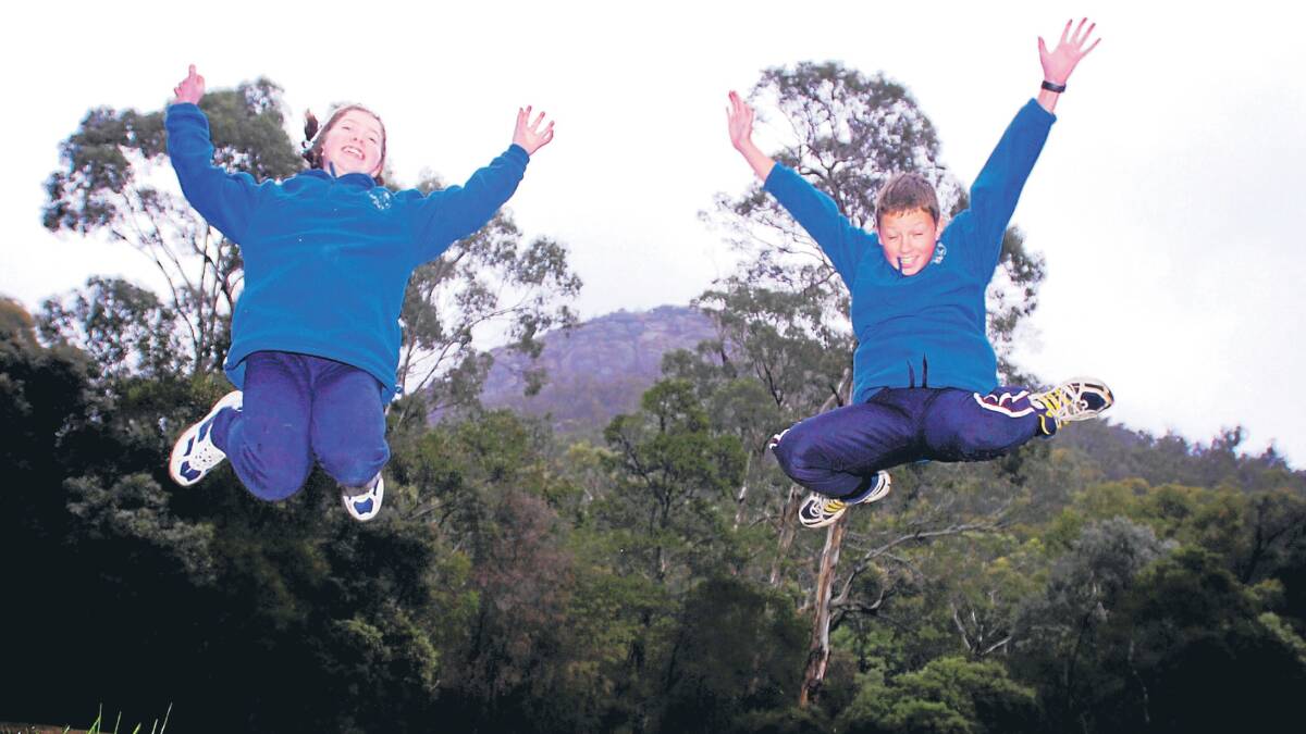 SENSATIONAL: Halls Gap Primary School senior students Sophie and Andreas celebrate news the school has won its campaign to have Mackey’s Peak in the Grampians National Park officially recognised as its original name Cherub Peak. Note: The school declined to provide surnames for the two students pictured. Picture: TIM HESTER