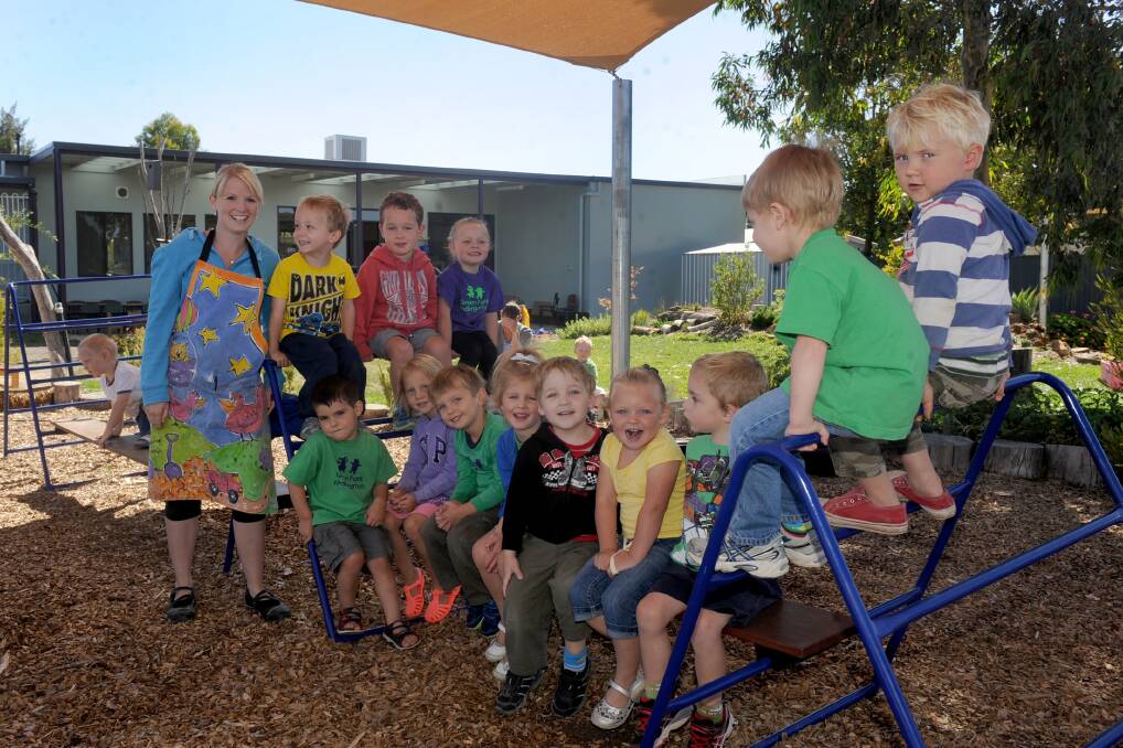 TRYING IT OUT: Teacher Katie Waterfield and her three-year-old Platypus group from the Green Park Kindergarten in their new playground provided through a combined community effort. Picture: SAMANTHA CAMARRI