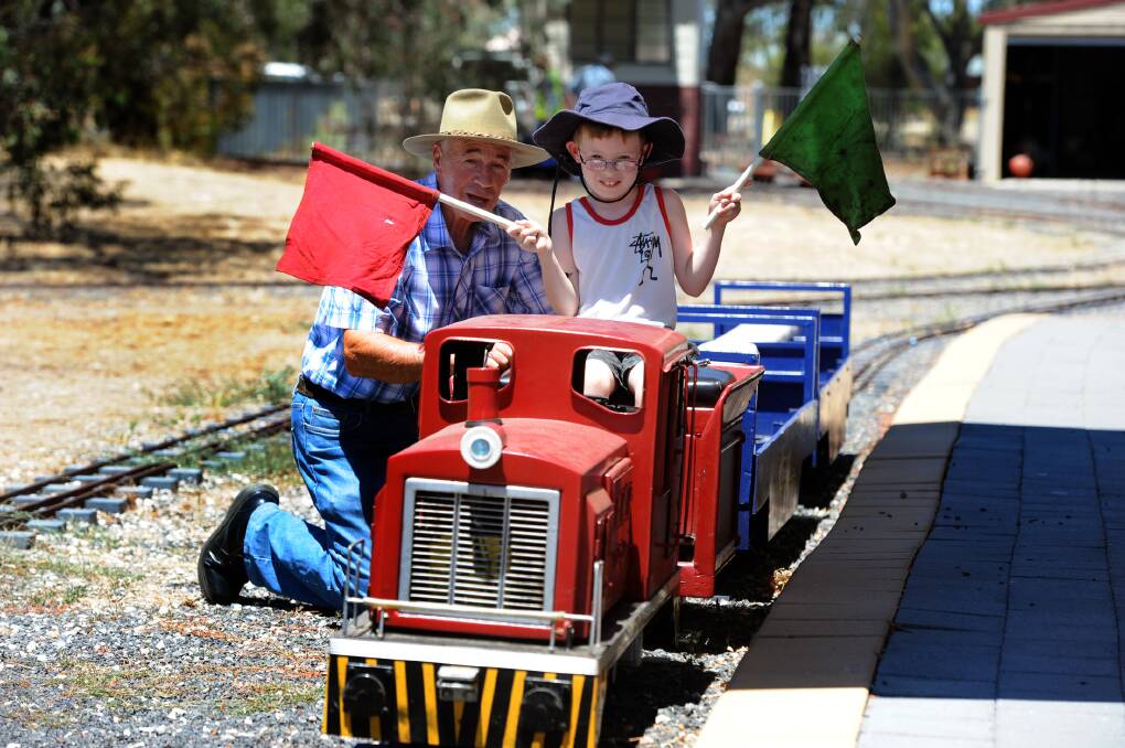 JANUARY: Austin Jones gives engineer Neville Price a hand at Sawyer Park Miniature Railway.