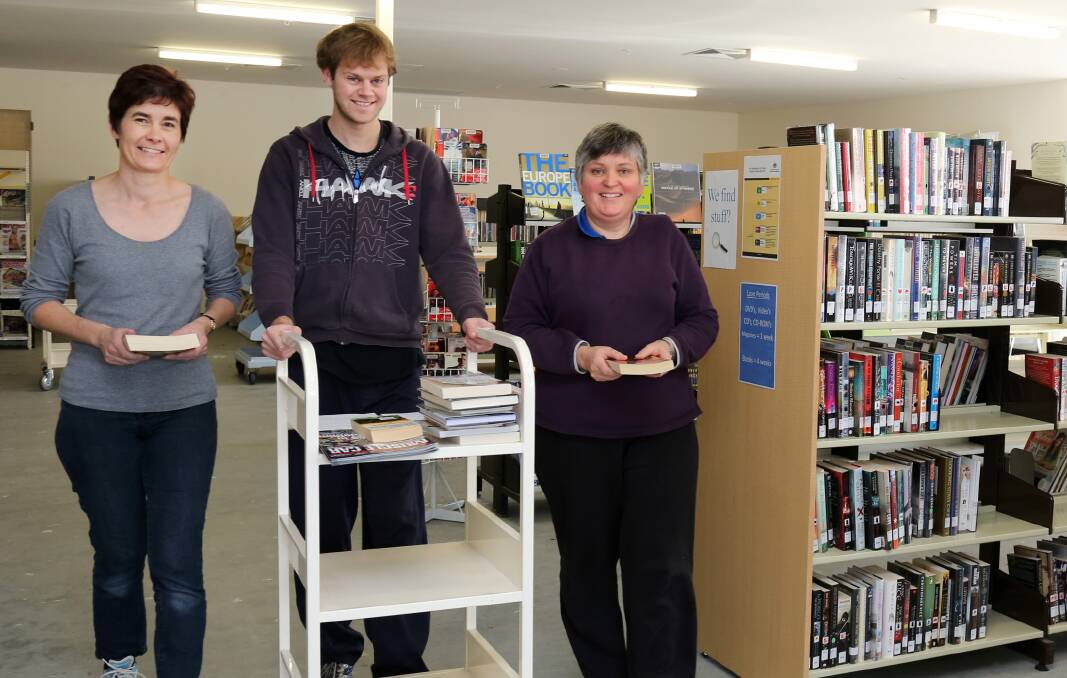 ON THE MOVE: Margaret Barbetti, Simon Grosser and Pauline Lentsment help set up Horsham Library’s temporary new home in the Gateway Centre. Picture: THEA PETRASS