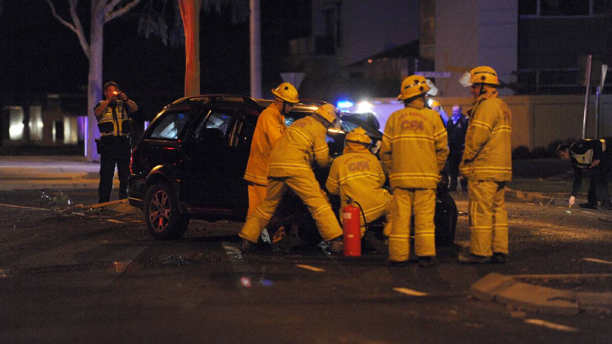 Emergency service crews attend the crashed car in Urquhart Street, Horsham. Picture: PAUL CARRACHER