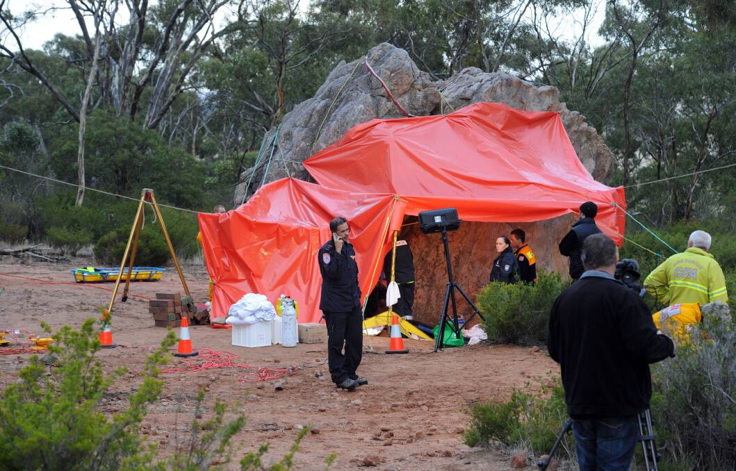 BETWEEN A ROCK AND A HARD PLACE: Rescuers work to free a man trapped at Mt Arapiles.