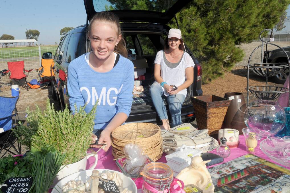 READY TO SELL: Horsham's Millie Smith, 14, with Sam Spence prepare their wares at the Horsham West Primary School car boot sale on Sunday.