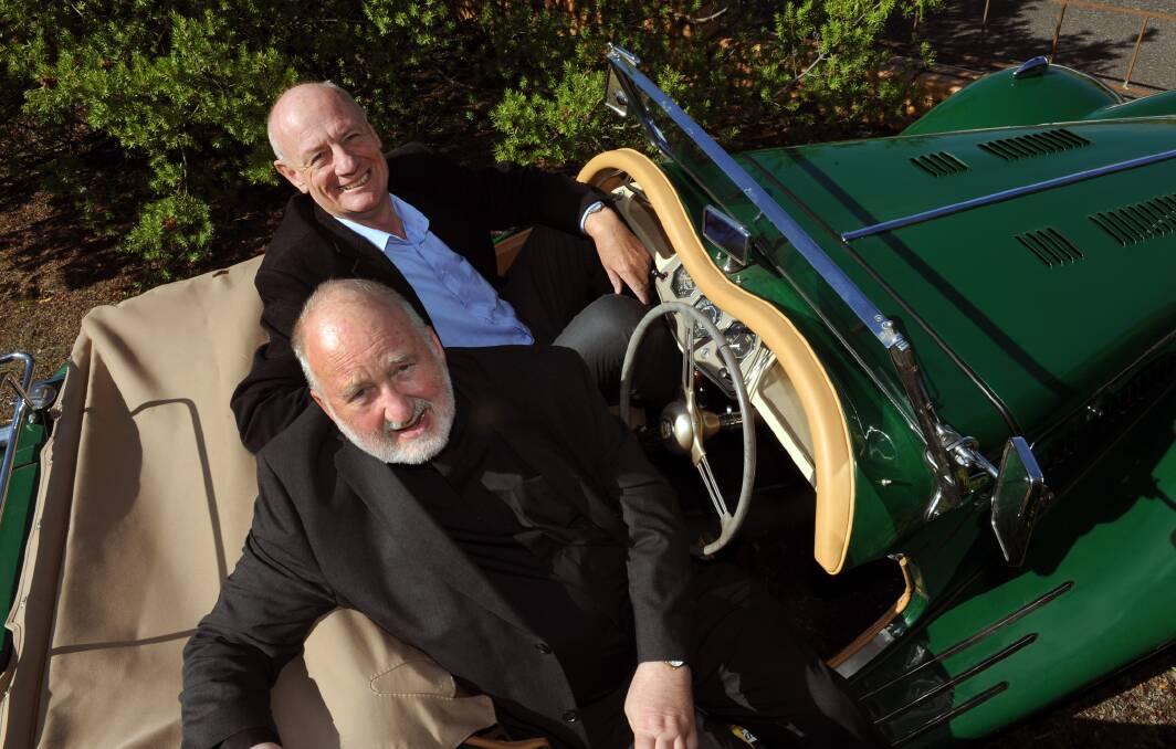 VISIONARY: World Vision Australia chief executive Tim Costello, back, takes a spin in St Andrew’s Uniting Church pastor Colin Honey’s MG during a visit to Ararat on Sunday. Pictures: PAUL CARRACHER