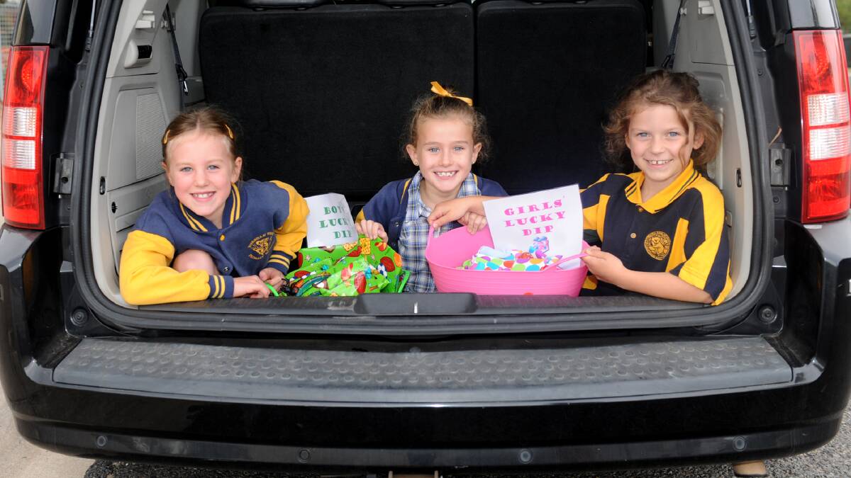GOODIES GALORE: Tiani Grosser, Madison Scott and Sophie Quick get ready for the Horsham West Primary School parents club’s car boot sale fundraiser. Picture: SAMANTHA CAMARRI