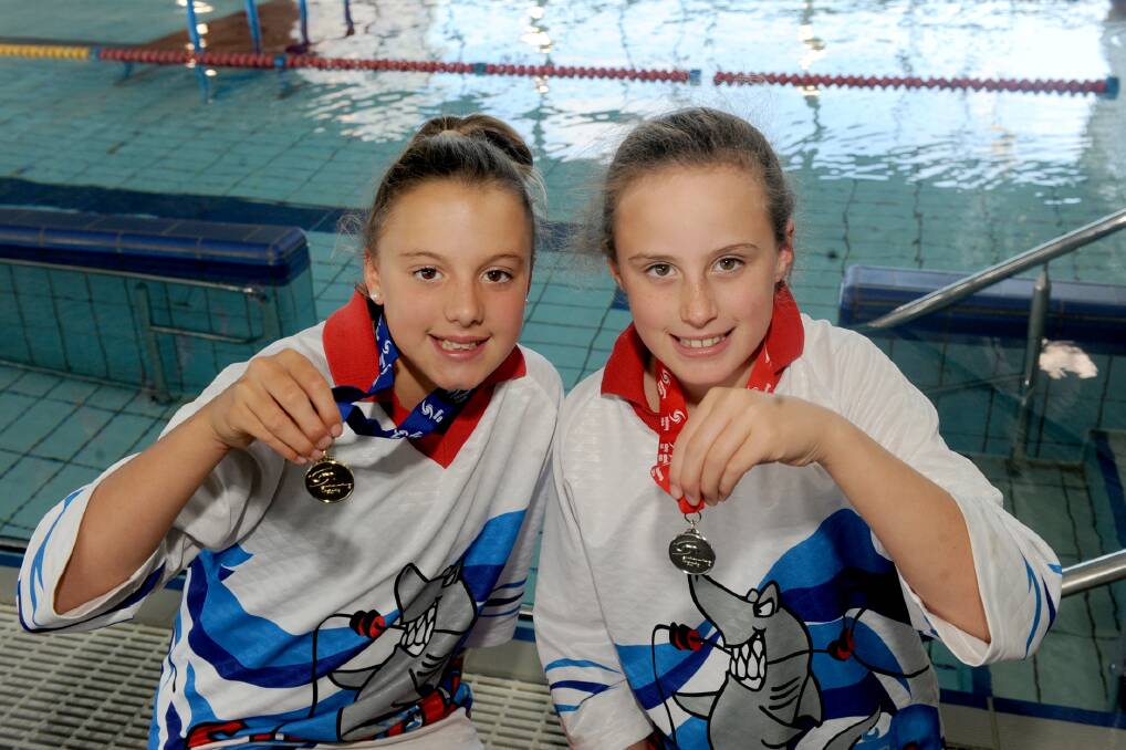WINNING FEELING: Horsham Swimming Club’s Miette Hopper, 11, and Eloise Wills, 8, won a gold and silver medal respectively at the Swimming Victoria All Junior Country Finals in Melbourne at the weekend. The club posted its best results to date at the event. Picture: SAMANTHA CAMARRI