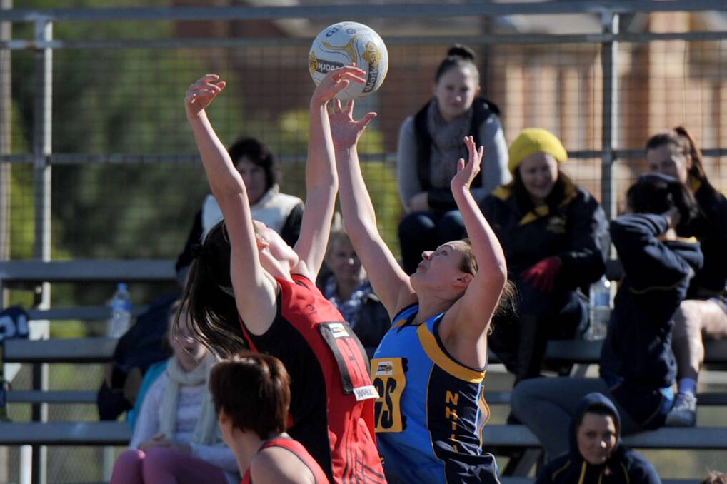 HIGH REACH: Stawell’s Meg Walker jostles for position with Nhill’s Emma Smith at Central Park, Stawell on Saturday. Both were named among their side’s best players, with Smith shooting 46 of the Tigers’ 49 goals. Picture: SAMANTHA CAMARRI