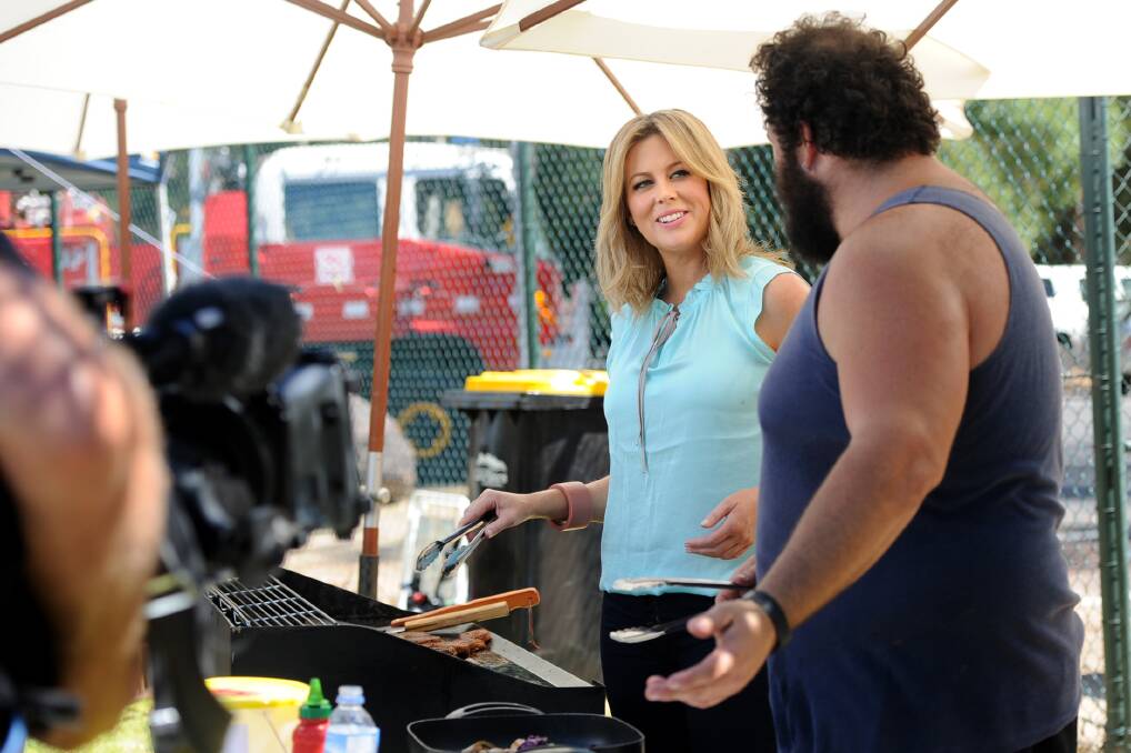 BARBECUE BANTER: Channel 7 presenter Samantha Armytage chats with Halls Gap Cricket Club president Ned Leithhead as the pair cook up a storm during a day of thanks for the region’s fire-fighters in Halls Gap on Saturday.