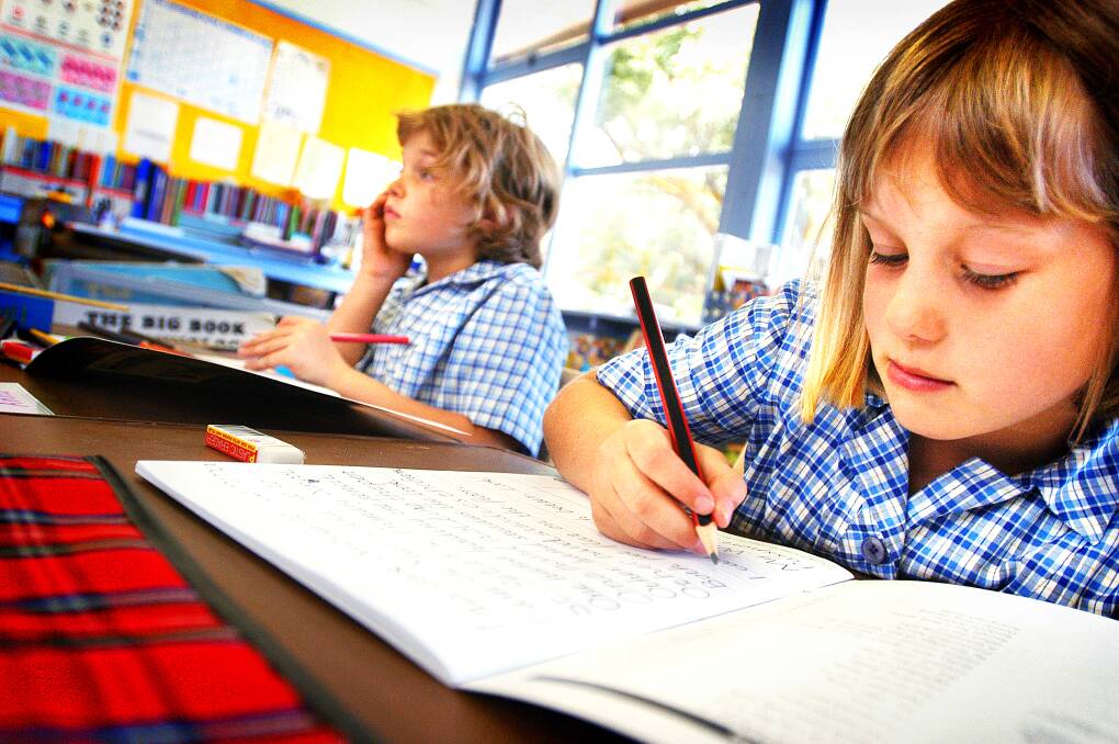 2005: St Peter's Lutheran School students Anna Kerber, 8, and Jemma Schultz, 7, practise their writing skills.