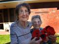 Kurrajong Lodge residents Doris Matthews and Edna Elliott with poppies knitted to represent the Field of Flanders. Mrs Matthew’s husband Jack had a nephew, Alex Cameron, in the war. Mrs Elliott’s brother Clarrie Albrecht was also in the war.  Lodge residents, friends and family members knitted 763 poppies for Anzac Day. Picture: PAUL CARRACHER