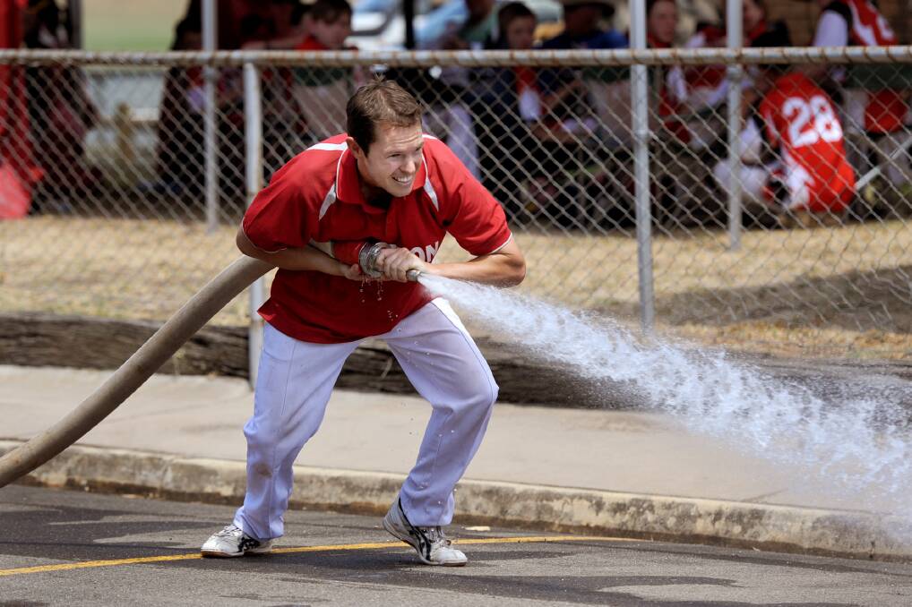 Ray De Mack of Kyneton competes in the seniors hose and reel event at the CFA District 17 Marshal Day.