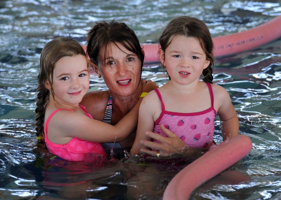 JANUARY: Leisa Uebergang with twins Emma and Hayley at the Horsham Aquatic Centre Australia Day pool party.