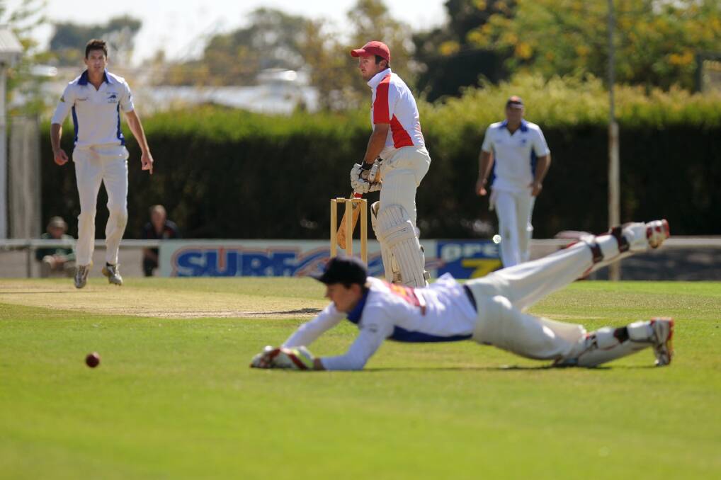 Dan Clark dives for the ball while Lachie Jones bats during the Rup-Minyip v Homers A Grade grand final.