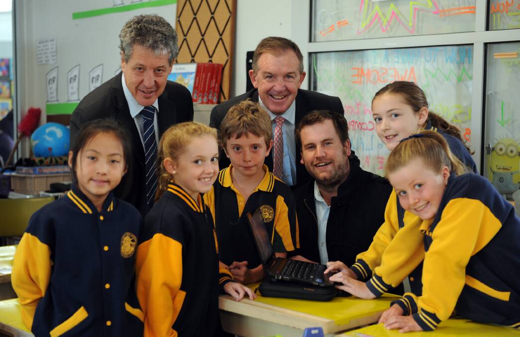 ONLINE LEARNING: Horsham West and Haven Primary School principal Brendan Bush, Member for Lowan Hugh Delahunty and teacher Ben Miatke are pictured with students Ella Zhu, 8, Gemma Walker, 9, Deegan McKenry, 8, Alannah Chester, 10, and Lily Bardell, 8. The school is part of a new international technology program. Picture: PAUL CARRACHER