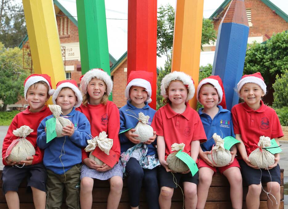 DECEMBER: Alex Morgan, Zac Oxbrow, Paige Hemley, Abby Oxbrow, Adelle Weidemann, Archie McQueen and Taylor Maggs show off Christmas puddings made by family members to raise money for Rupanyup Primary School.