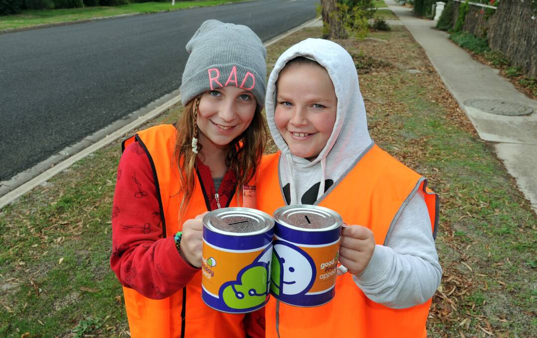 HARD AT WORK: Chloe Mackley, 12 and Brooke Groves, 11, collect for the Royal Children's Hospital Good Friday Appeal in Drummond Street, Horsham.