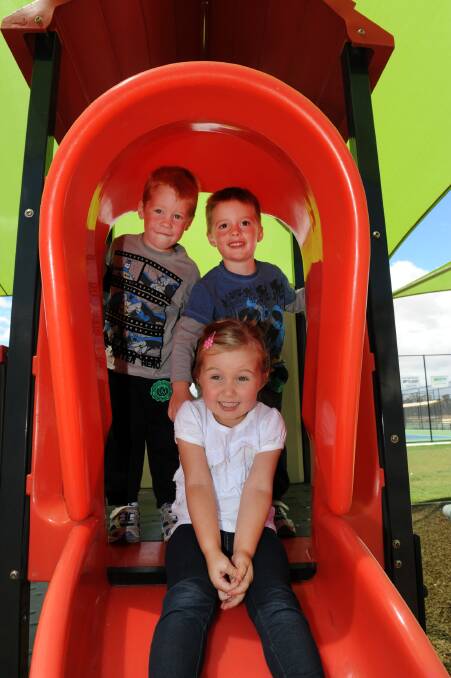 FUN AND GAMES: Haven Community Playgroup leaders have invited Wimmera children to join in the fun on Tuesday mornings. Jayda Mills, 3, enjoys the slide at the playgroup’s new playground, while twins Jack and Harry Toet, 3, wait their turn. Pictures: PAUL CARRACHER